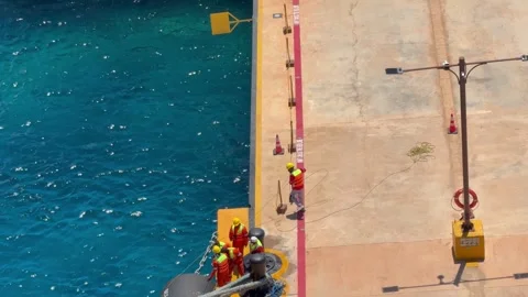 4K Wide High Angle Of Harbor Crew Securing Cruise Ship Mooring Lines Stock-Footage 335480231