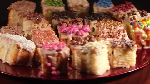 4K Wide High Angle View of Assorted Decorated Cakes Rotating Fast to the Right Stock Footage 333319058