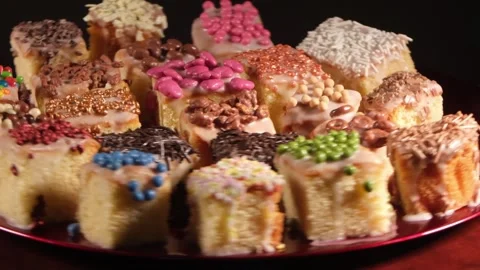 4K Wide High Angle View of Assorted Decorated Cakes Rotating Fast to the Left Stock Footage 333319098
