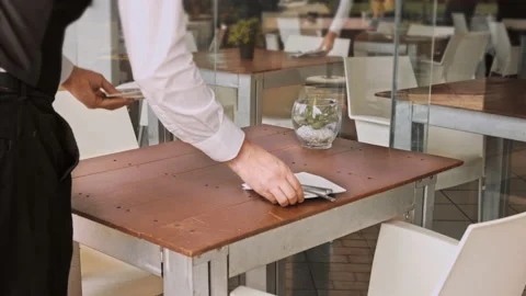 4k wide medium of waiters setting the table for new customers in local cafe rest Stock Footage 201094739
