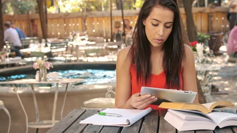 4k wide shot of casually dressed woman student with tablet computer doing homewo 스톡 동영상 201094148