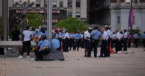4K WIDE SHOT COPS SITTING AND STANDING TOGETHER IN PHILADELPHIA CITY HALL Stock Footage 131460474