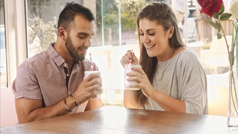 4k wide video of multicultural dating couple drinking milkshakes in cafe. Stock-Footage 201094518