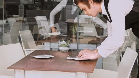4k wide video of waiters setting the table for new customers in local cafe resta 库存影片 201094528