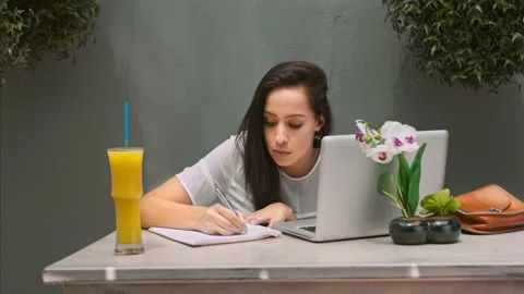 4k wide video of young Latin Hispanic woman working on modern laptop in garden c Video stock 201096680