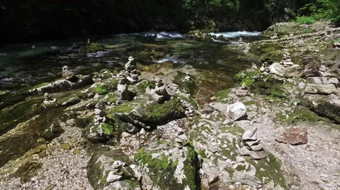 4K. Wild Radovna river flows in Vintgar Gorge and stone pyramids. Video stock 65407571