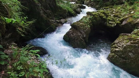 4K. Wild river flows in Alps Mountains, clean blue water. 動画素材 65211003