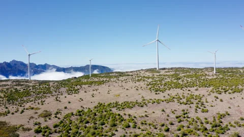 4K Wind generators spinning in deserted rural area clouds and mountains in backg Stock Footage 242807190