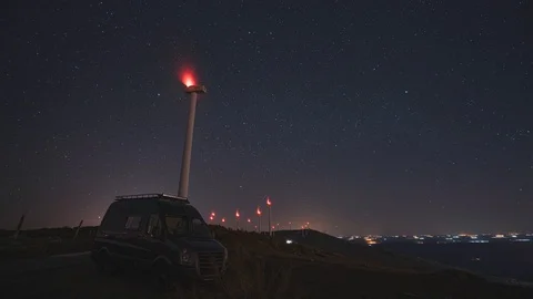 4K. Wind Turbines Generating Power At Night Timelapse With campervan van life Stock Footage 129149866