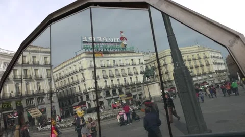 4K Window reflection crowded Puerta del Sol Madrid landmark Gate Sun square day  Stock Footage 61424060