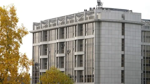 4k window washers on the side of a modern building. Stock Footage 82553053