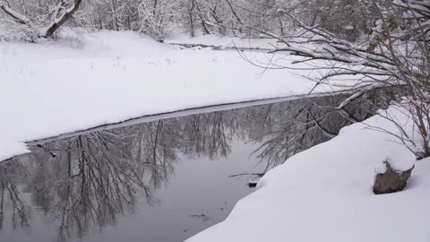 4K Winter River Stream Flow Snow Covered Banks Deciduous Tree Zone Stock-Footage 334463936