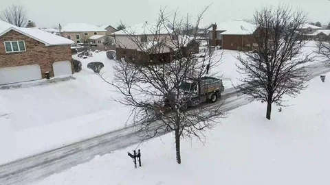 4k Winter storm snow removal from residential streets with snow plough Stock Footage 85676733