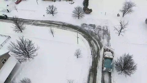 4k Winter storm snow removal from residential streets with snow plough Stock Footage 85676747