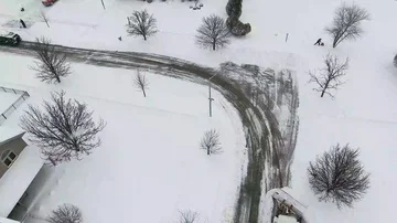 4k Winter storm snow removal from residential streets with snow plough Stock Footage 85677161