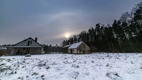 4k winter time lapse with house in forest under cloudy sky. Stock Footage 167609854