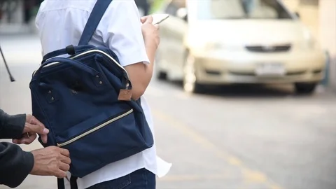 4K Woman on city street is unaware that her purse has been stolen Stock Footage