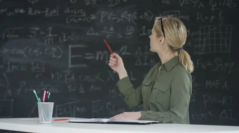 4K Woman in classroom writing in book bl... | Stock Video | Pond5