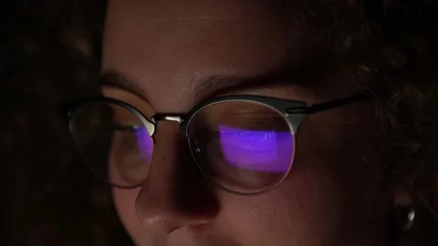 4K, Woman with glasses browsing with the computer late at night. Person working. Stock Footage 147850595