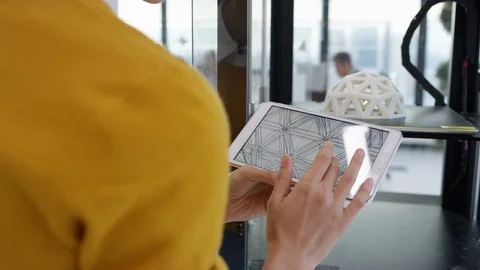 4K Woman looking at prototype in 3D printer &amp; checking design on tablet computer Stock Footage 73822276