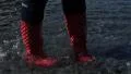 4K woman in red boots are walking in the water, very dark footage 4k or 4k+ Resolution
