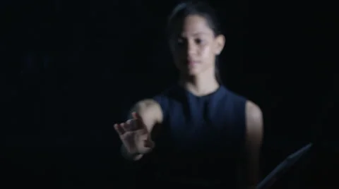 4K Woman using computer tablet &amp; interactive touch screen on black background Stock Footage 64055979