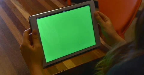 4K Woman using tablet computer green chroma-key screen close-up one swipe Stock Footage 51054876