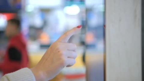 4K Woman using touchscreen terminal in mall. Detail view outstretched female Stock Footage 251014983