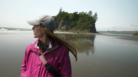 4K Woman Walks Away From Ruby Beach Ocean Boulder Stock Footage 109036152