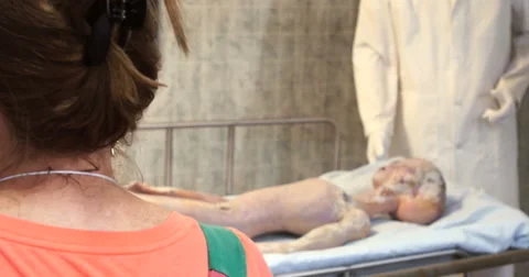 4K woman's head looking at display of alien autopsy in ufo museum Roswell, NM Stock Footage 54078965