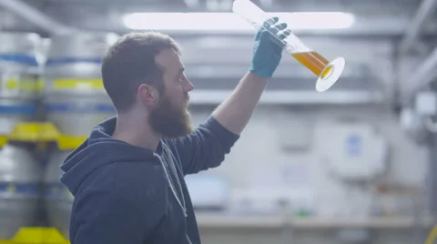 4K Worker in a brewery tasting beer & checking quality of the product Stock Footage