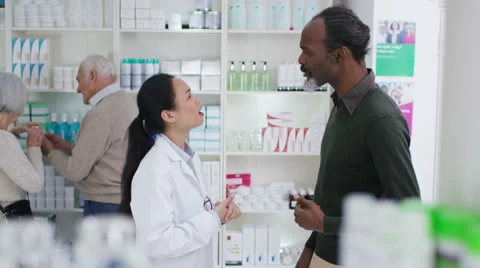 4K Worker in a chemist shop assisting mature gentleman Stock Footage 59061386