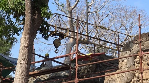 4K Workers in the construction with scaffolding and crane at Ta Prohm temple-Dan Stock Footage 119060037