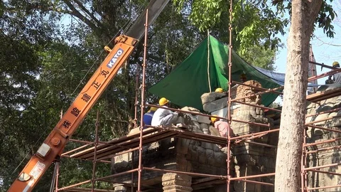 4K Workers in the construction with scaffolding and crane at Ta Prohm temple-Dan Stock Footage 119060043