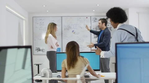 4K Workers at creative design company looking at whiteboard &amp; brainstorming Stock Footage 61374770