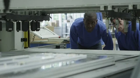 4K Workers in a factory operating machinery &amp; checking quality of products Stock Footage 72659356
