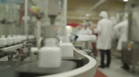 4K Workers in pharmaceutical manufacturing facility factory Stock Footage