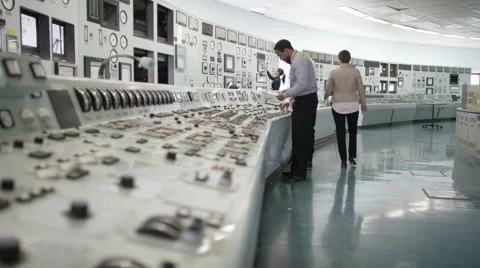 4K Workers in power plant control room, pressing switches on control panel Stock Footage