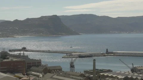 4k Yacht Sailing By Naval Dockyard Pier Ocean Mountains In Background Stock Footage