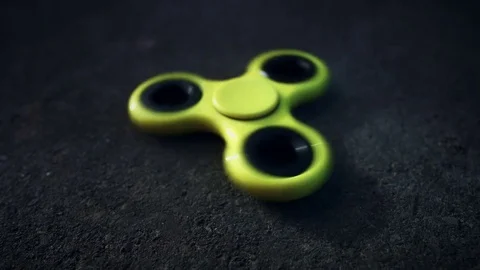 4K Yellow Fidget Spinner on the Ground Stock Footage