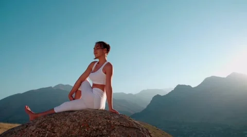 4K yoga in the mountains,the sunrise, beautiful girl in white clothes doing yoga Stock Footage