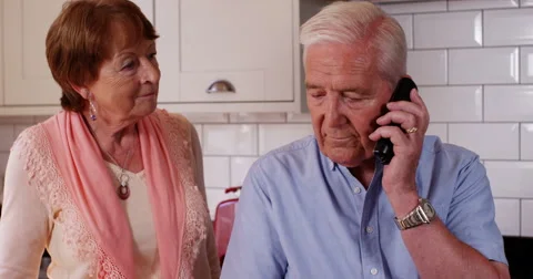 4k, You have a call.. Old couple receive a phone call on their mobile phone. Stock Footage 67226461