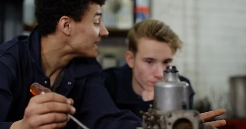 4K Young apprentice mechanic with bad attitude showing no interest to learn Stock Footage 112975045