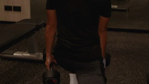 4k Young Asian man doing dumbbell leg lunges exercise at the gym, evening, Stock Footage 121189544
