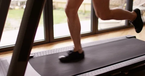 4K Young Asian man working out on running machine in home gym. Slow motion. Stock Footage 86730922