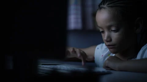 4K Young child typing on a keyboard in the dark at night, in slow motion Stock Footage 56729093