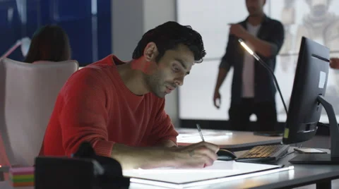 4K Young computer game design team working together in dark office Stock Footage 67902802