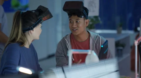 4K Young computer game designers looking into VR viewers &amp; discussing a project. Stock Footage 67514319