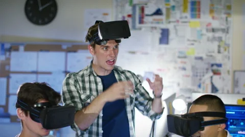 4K Young computer programmers trying out virtual reality viewers Stock Footage 54448164
