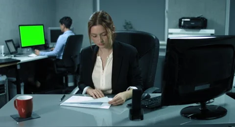 4K: A young controller is analyzing some financial reports in an office Stock Footage 66640383